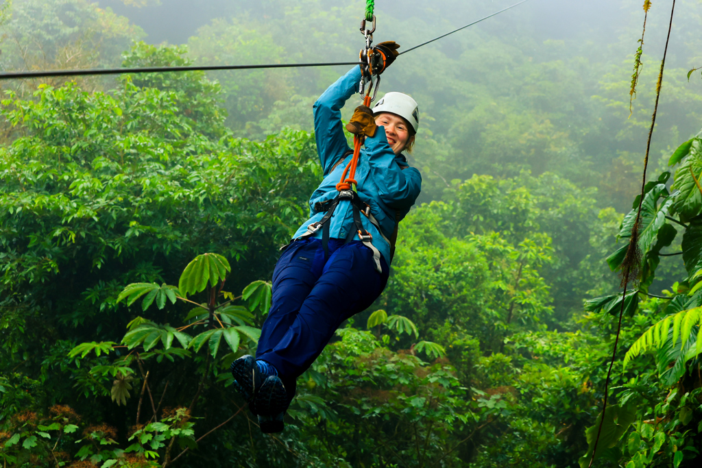Jonge reiziger tokkelt door het regenwoud in Costa Rica tijdens een 22-35ers groepsrondreis.