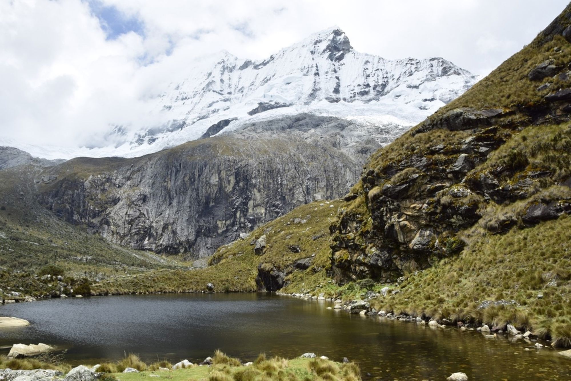 Sneeuwbedekte bergtop boven een bergmeer in de Peruaanse Andes.