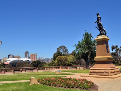 Monument in Adelaide met uitzicht op de skyline en het Adelaide Oval onder een strakblauwe lucht.