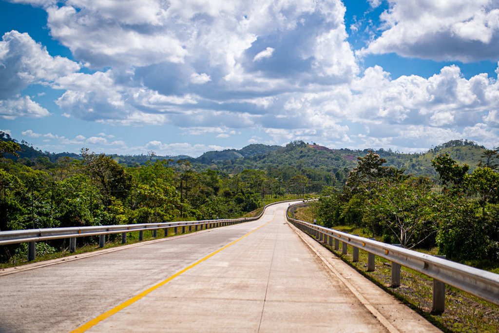 Pan-American Highway door groen heuvelachtig landschap tijdens groepsrondreis Trans-Midden-Amerika.