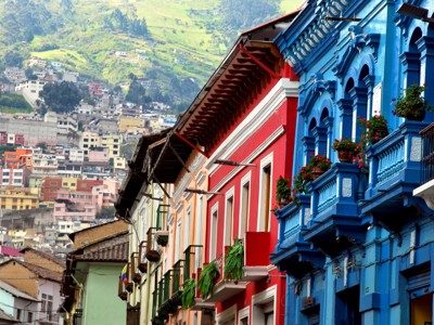 Kleurrijke straat met historische gevels en balkons in Quito, Ecuador.