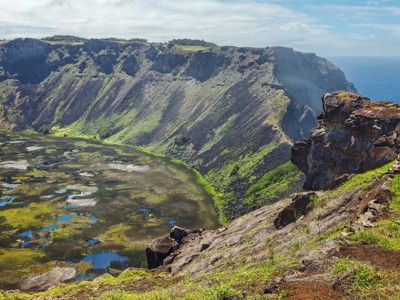 Uitzicht over de krater van Rano Kau met het kratermeer en de oceaan op Paaseiland.