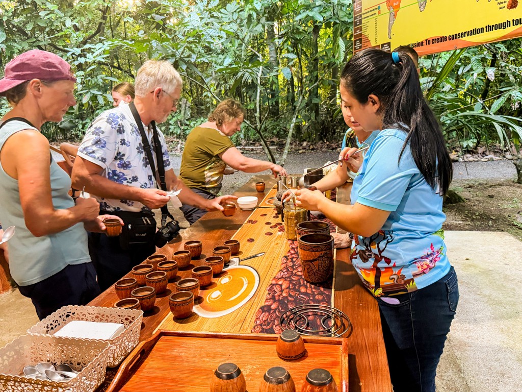 Koffieproeverij tijdens groepsrondreis Costa Rica Hoogtepunten, met reizigers die lokale koffie proeven aan een tafel.