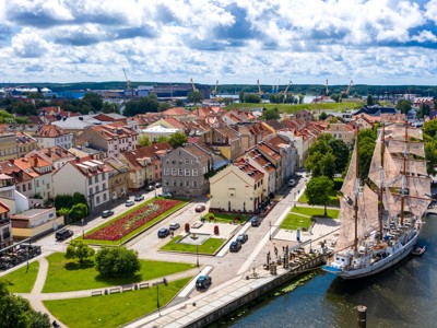 Uitzicht op de oude haven van Klaipėda met zeilschip en historische huizen, route Baltische Staten.