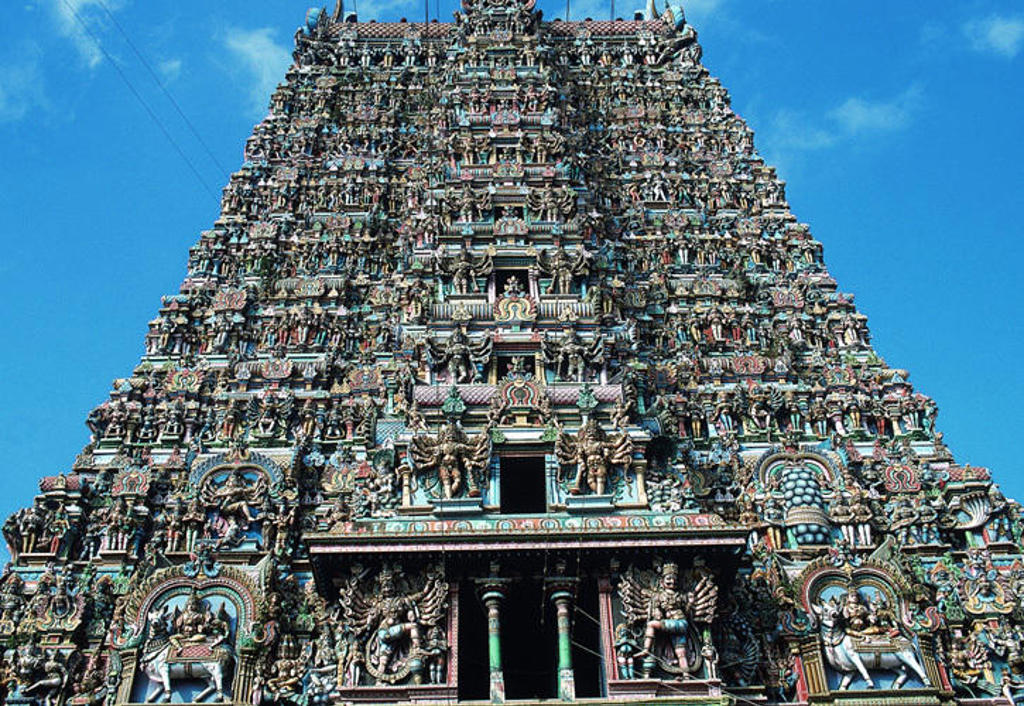 Rijk versierde hindoetempel-gopuram in Zuid-India onder een heldere blauwe lucht.