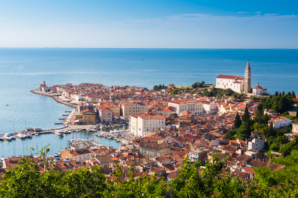 Uitzicht op kuststad Piran met haven en kerk aan de Adriatische Zee, Slovenië.