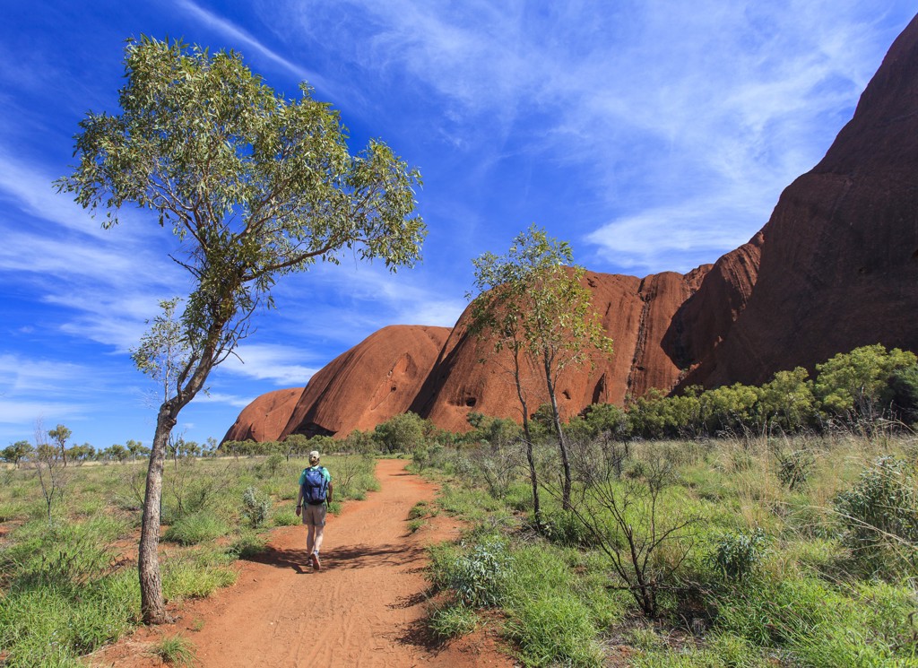 Wandelaar op het pad bij Uluru (Ayers Rock) tijdens een groepsrondreis door Australië.