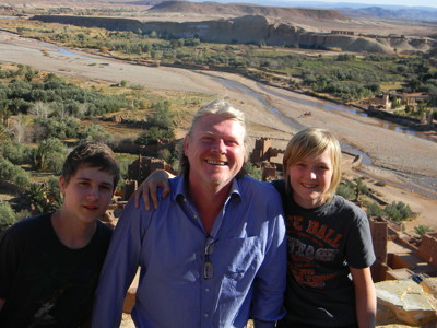 Vader met twee kinderen bij kasbah in de Dadesvallei, tijdens Route Marokko Familiereis.