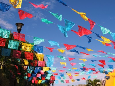 Kleurrijke papel picado-slingers boven een straat in Mexico tijdens de Route Mexico.