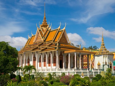 Koninklijk Paleis in Phnom Penh, Cambodja, met gouden daken en tempelarchitectuur onder blauwe lucht.