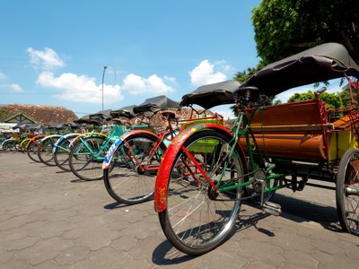Rij kleurrijke becaks (fietstaxi’s) geparkeerd in Yogyakarta, Java.