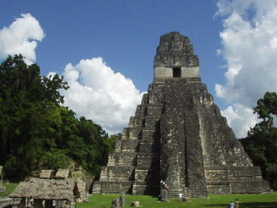 Tempel I in Tikal, Guatemala, met jungle en wolkenlucht op de achtergrond.