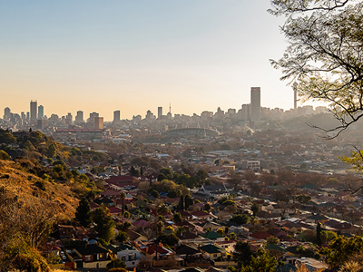 Uitzicht op de skyline van Johannesburg bij zonsondergang tijdens de Route Zuid-Afrika.