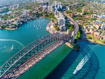 de Sydney Harbour Bridge met de skyline van Sydney en boten in de haven, Australië.