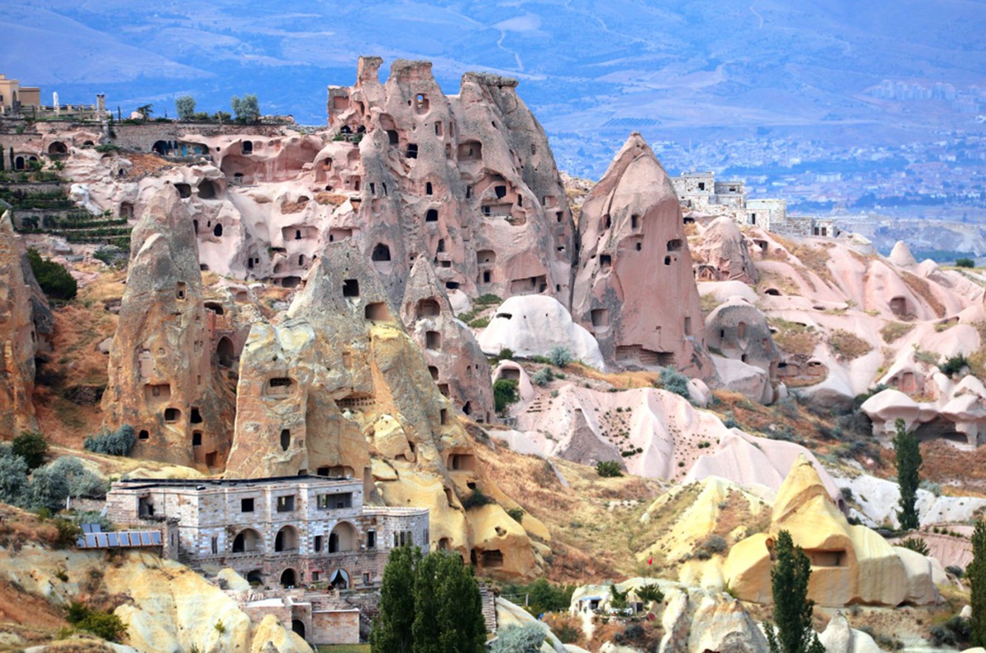 Rotsformaties met uitgehakte grotwoningen in Cappadocië, Turkije.