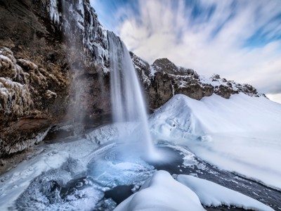 Bevroren waterval in een besneeuwd landschap tijdens de Route IJsland Winter, dag 6.
