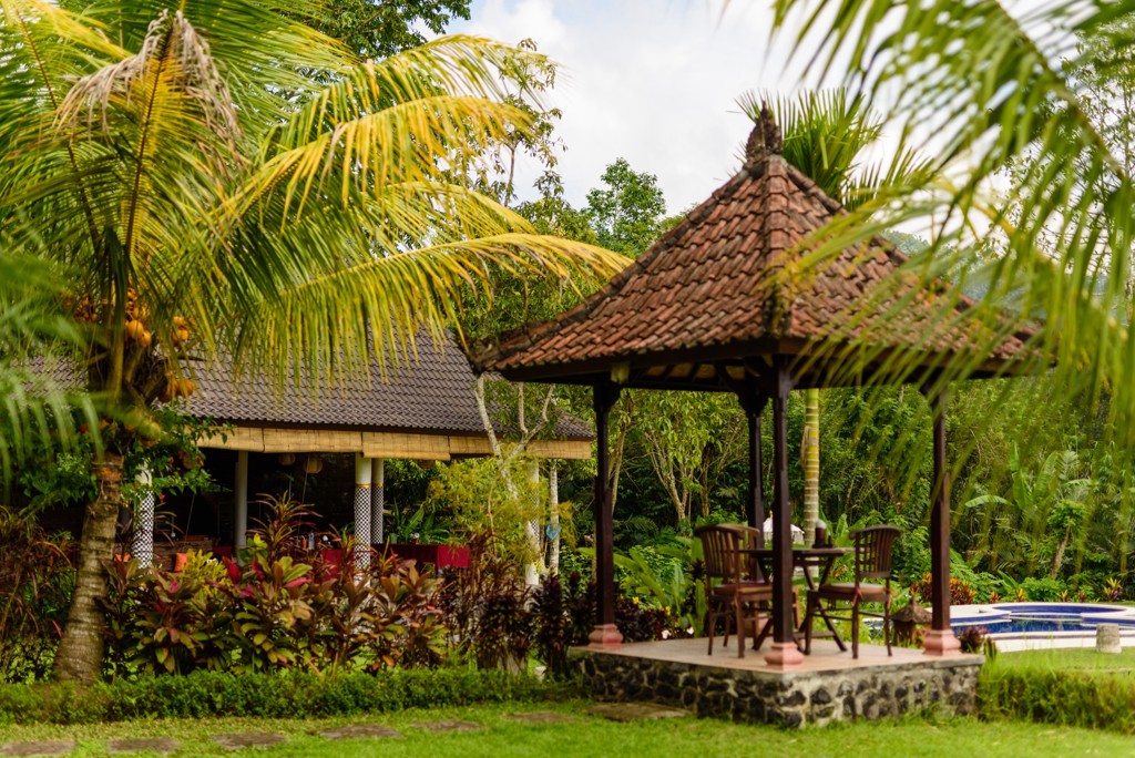 Tropische tuin met gazebo en zitje bij een resort op Java of Bali, Indonesië.