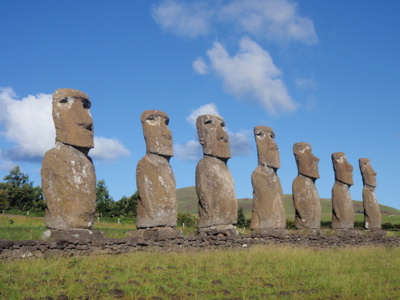 Moai-standbeelden op Paaseiland onder een blauwe lucht.