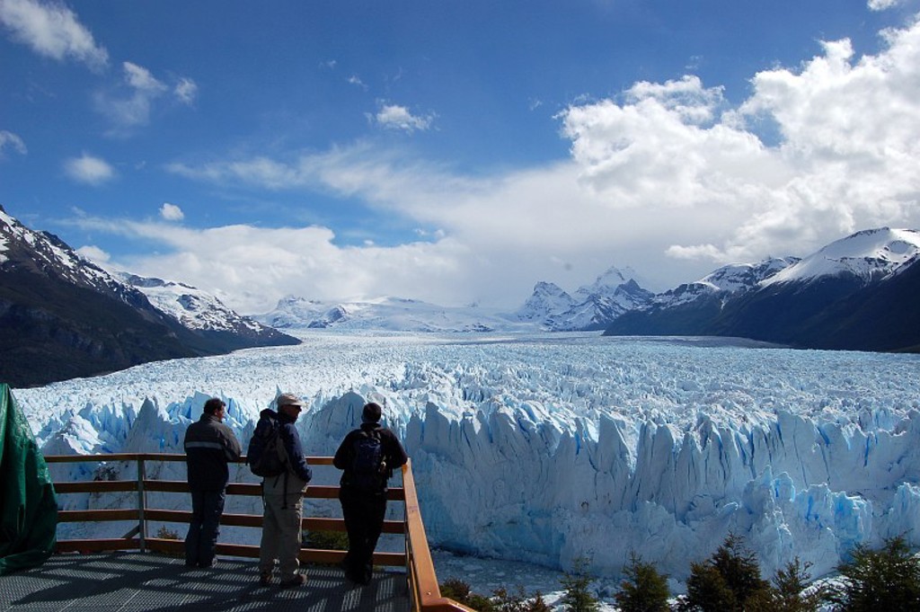 Uitzichtpunt bij de Perito Moreno-gletsjer in Patagonië, met reizigers en besneeuwde bergtoppen.