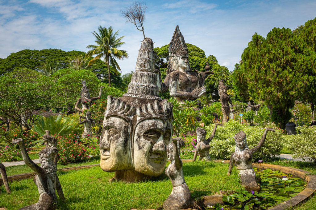 Beeldenpark met boeddhistische beelden en grote stenen hoofden in Vientiane, Laos.