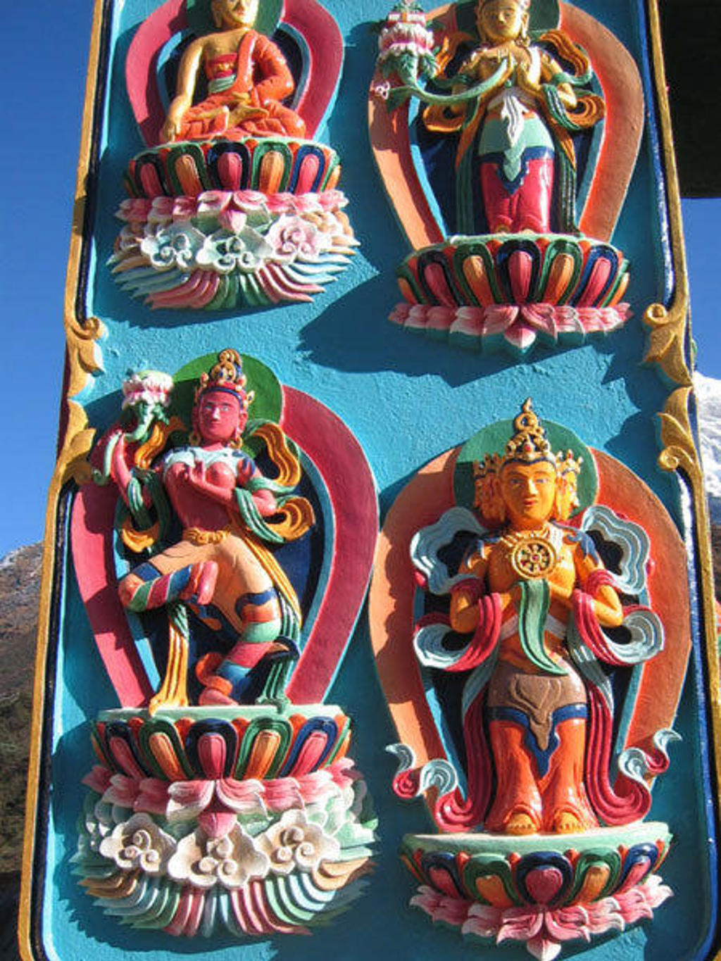 Kleurrijke boeddhistische reliëfs op een tempelmuur tijdens de groepsrondreis Nepal Everest.