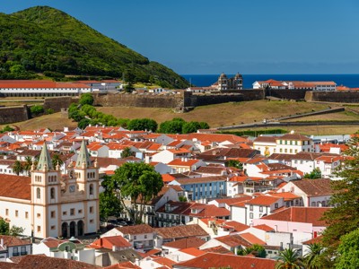 Uitzicht over Angra do Heroísmo op Terceira, Azoren, met rood pannendaken en vesting aan zee.