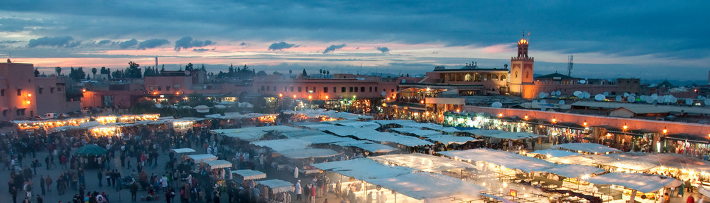 Djemaa el-Fna plein in Marrakech bij zonsondergang, met verlichte marktstalletjes tijdens een groepsrondreis Marokko.