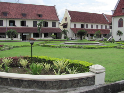 Fort Rotterdam in Makassar met witte gebouwen, rode daken en groene binnentuin op Route Sulawesi.