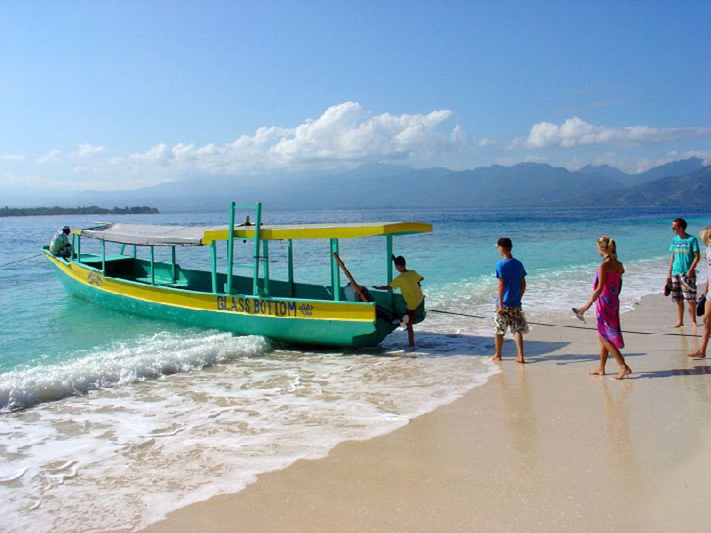 Boot met glazen bodem bij het strand van de Kleine Sunda Eilanden, tijdens een familiereis in Indonesië.