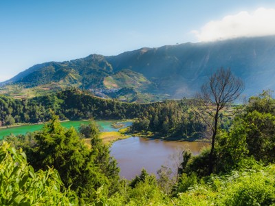 Uitzicht op het vulkaanlandschap rond het Dieng-plateau op Java, met meren en groene berghellingen.