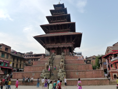 Nyatapola-tempel op Taumadhi-plein in Bhaktapur, Nepal, met trappen, stenen beelden en bezoekers.