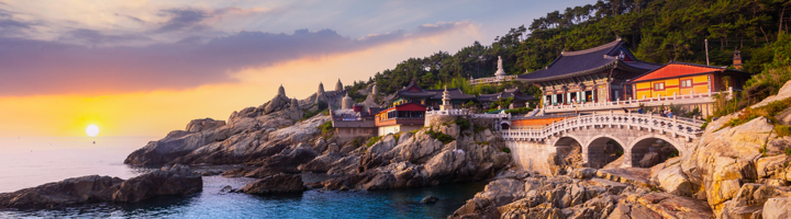 Haedong Yonggungsa-tempel aan de rotskust bij Busan tijdens zonsondergang, Zuid-Korea.