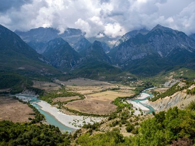 Uitzicht op een rivierdal met bergen in Albanië langs de route Albanië, Kosovo & Noord-Macedonië.