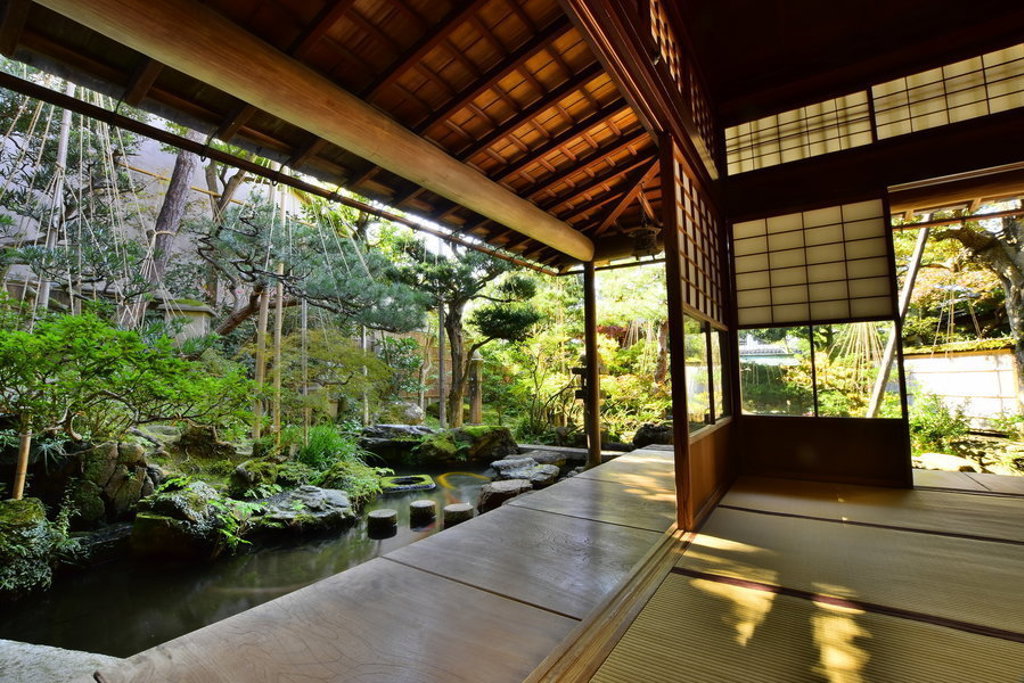 Traditionele Japanse theetuin met houten veranda, schuifdeuren en vijver, tijdens een familiereis Japan.